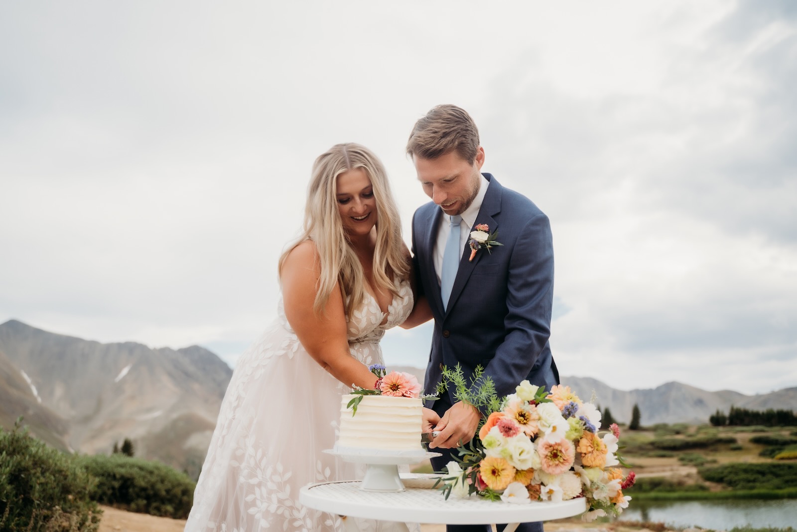 Couple cutting a small cake at their Colorado mountain elopement