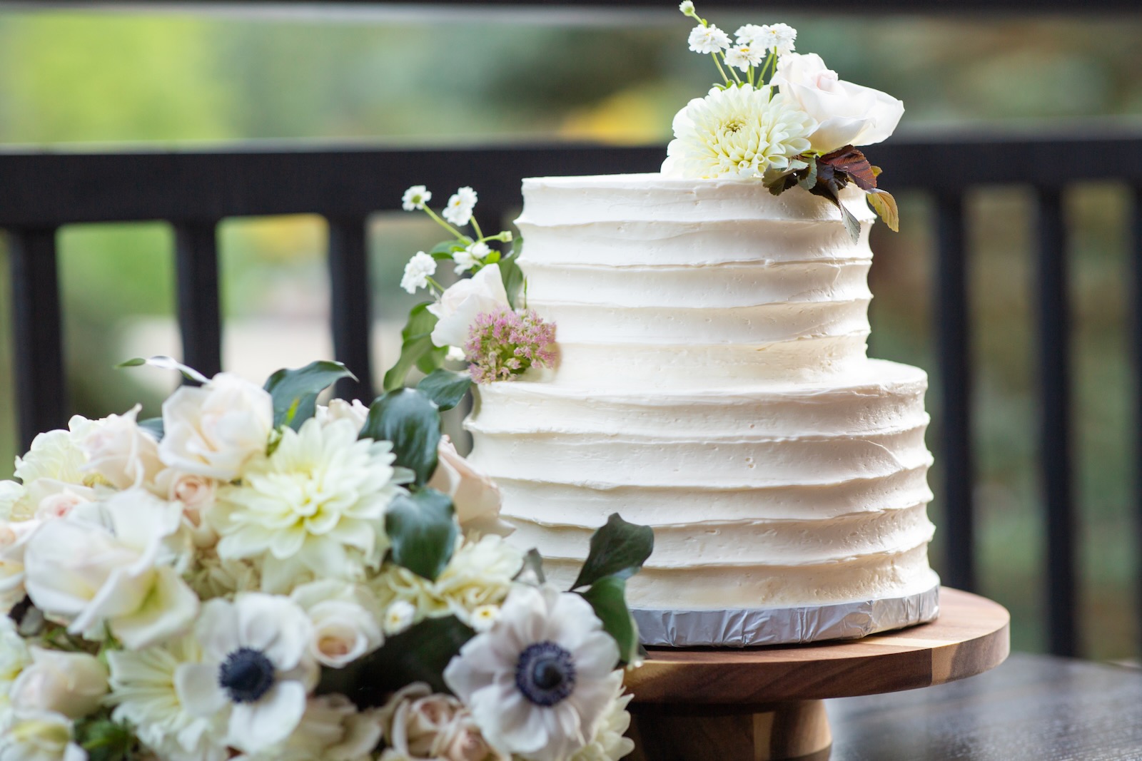 Two-tier white wedding cake with fresh florals from a Colorado wedding