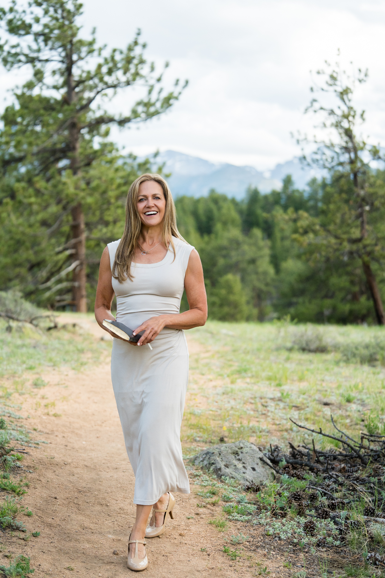 Wendee walking outdoors in Colorado before a wedding ceremony